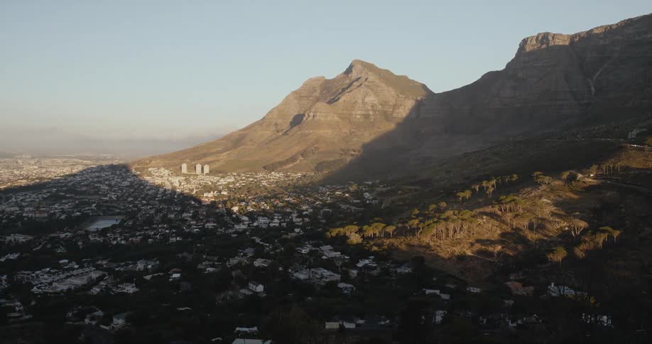 A canyon plateau casts a shadow on the neighborhood below