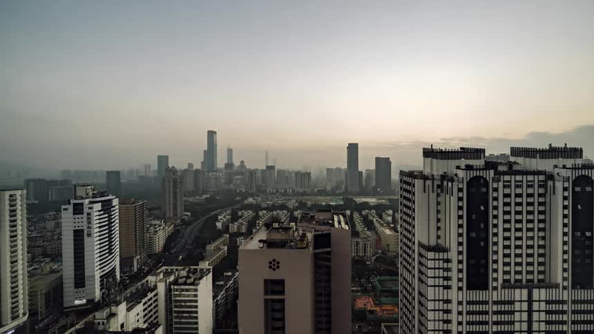 The sun rises over the skyscrapers of a metropolis
