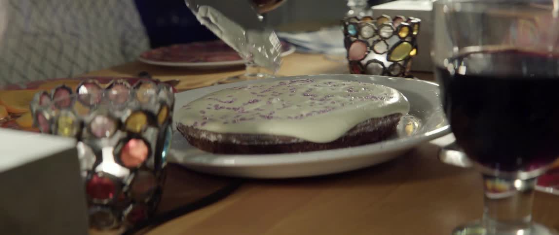 Person Carefully Cutting a Dessert With Knife Bringing Sweet Anticipation to a Shared Moment.
