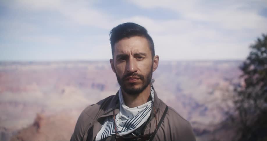 Man poses in front of canyon landscape