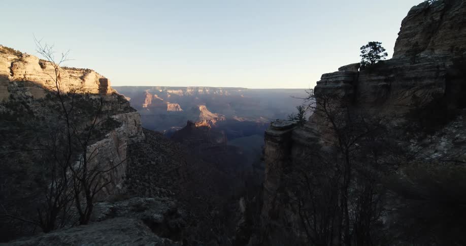 Shadows fill canyon as sun shines on plateaus and mesas