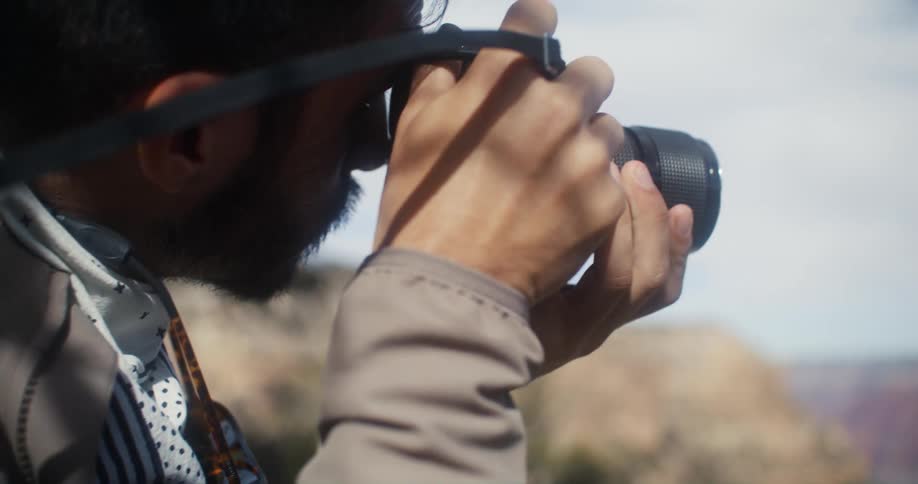 Male photographer takes picture of canyon