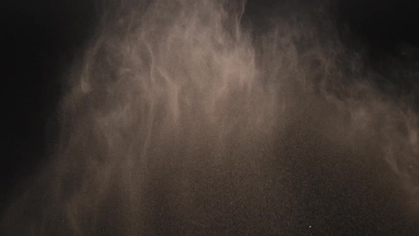 Sand flying through the air and turning in to dust