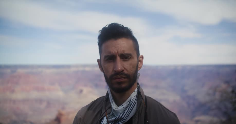 A portrait of a man standing outdoors at a canyon