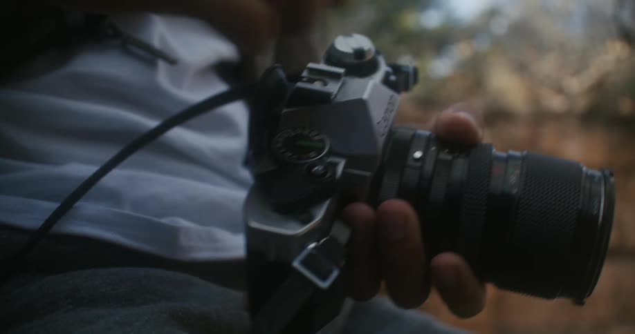 A man loads film in to a camera