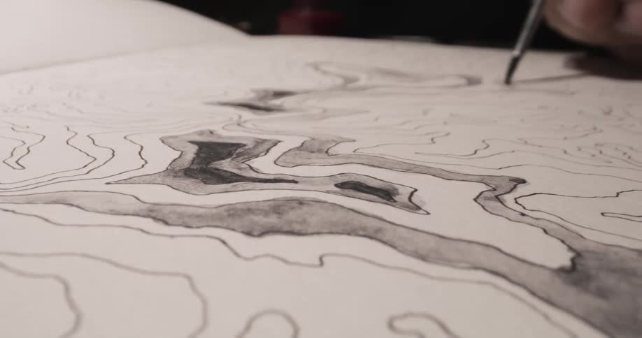 An artist is painting on a black and white line drawing