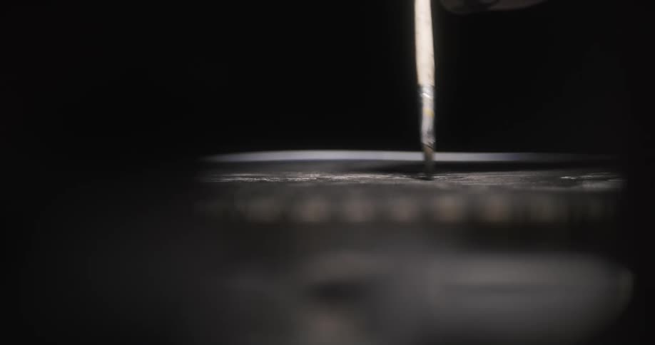 Surface reflects artists paint brush as paint is applied to canvas