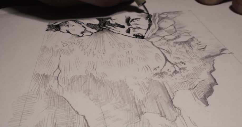 A person is using an ink pen to sketch and color in artwork