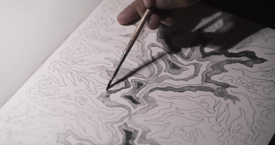 A person is drawing with a small brush