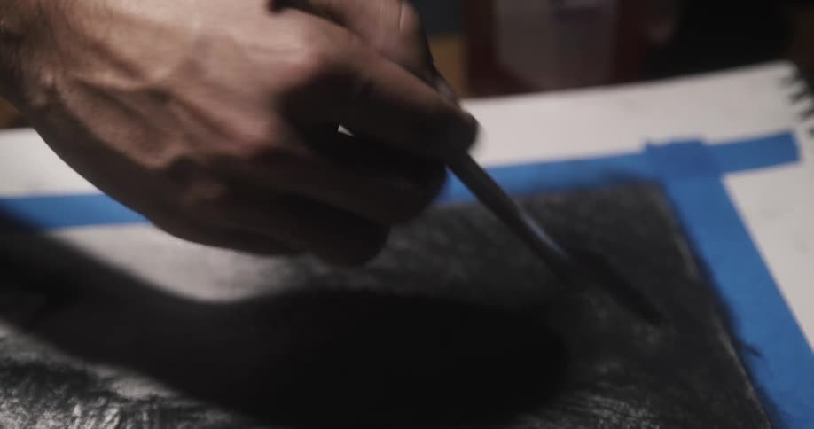An artist paints on a picture