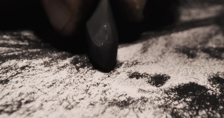 An artist sketches on paper