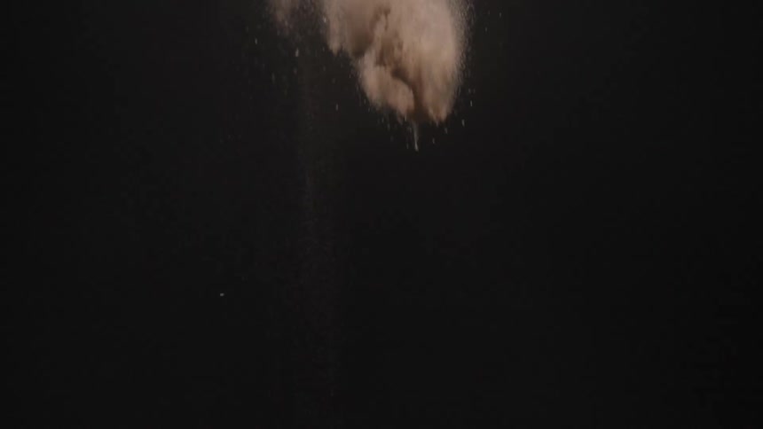 Water falls rapidly through the night