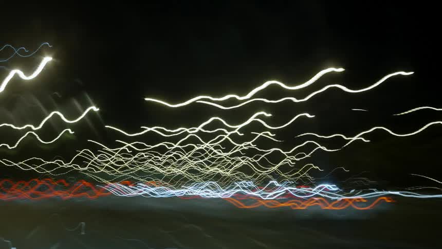 Light streaks form from taillights and streetlights at night