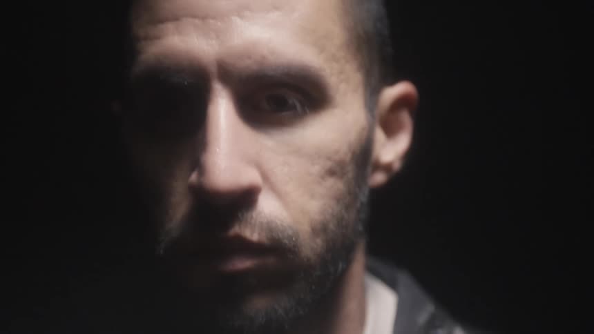 A man is jogging in the darkness of night