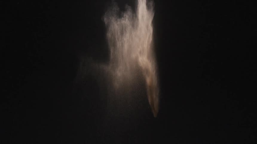 The dust falls slowly in the dark