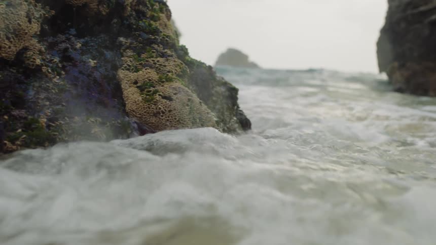 Foaming waves crash against outcropping