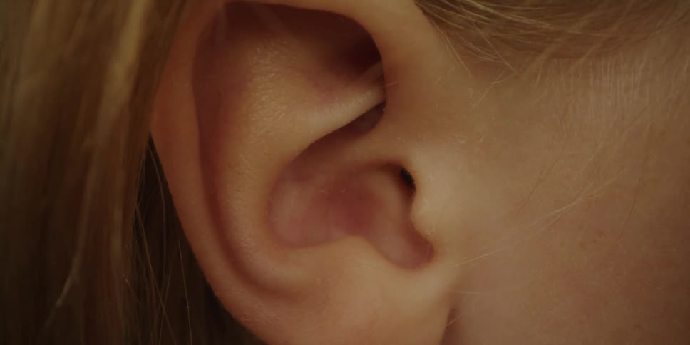 Close up of blonde girls ear