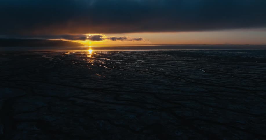 The sun setting over the horizon