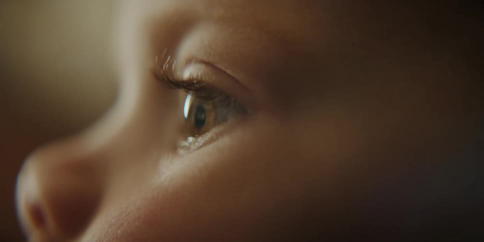 Close up of toddler boys face watching television
