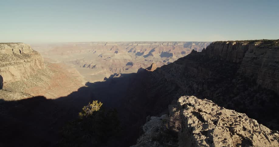 A vast canyon under a clear daytime sky