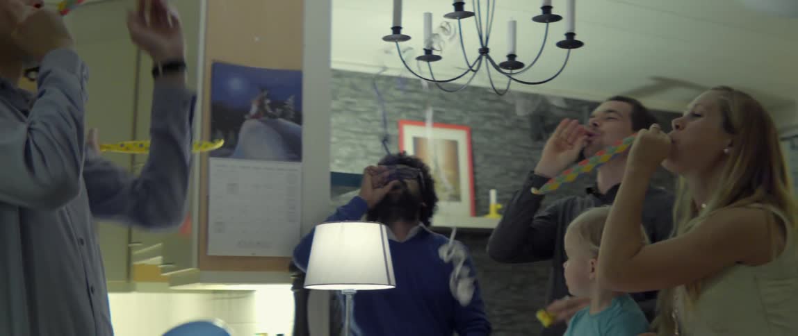 A group of people counting down and then blowing streamers