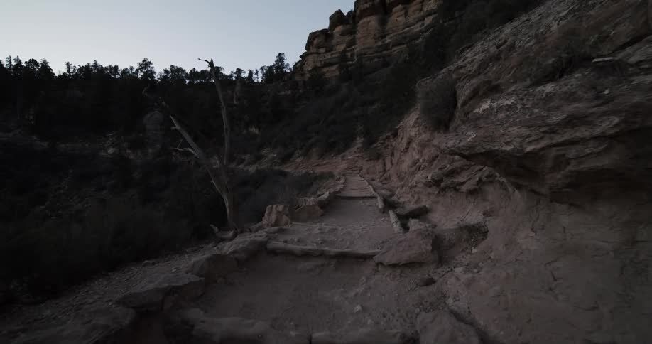A narrow walkway along the side of a mountain during the day