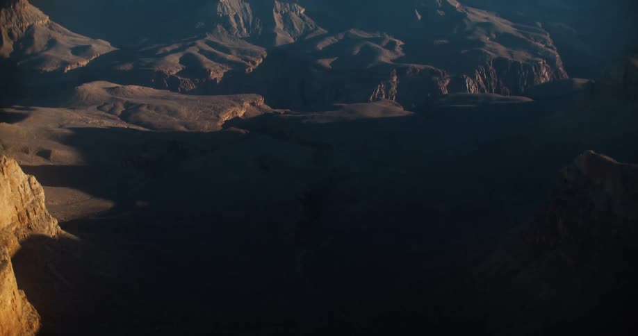A large barren mountain range is reflecting the sunlight