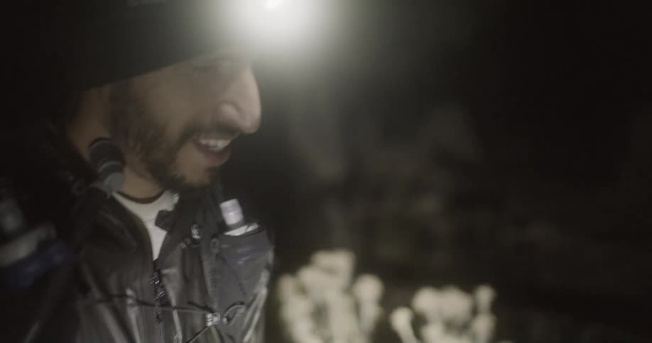 A man talks as he hikes at night