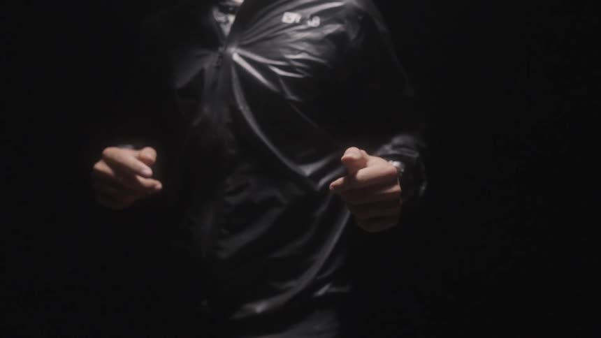The torso of a man running for exercise wearing a smart watch