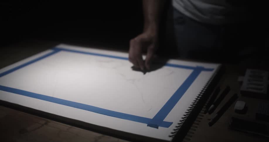 Artist sketches on large sketchpad