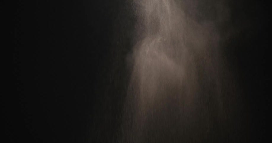 White powder falling against a blackboard