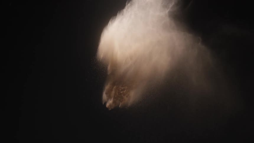 A large puff of smoke moves through the darkness