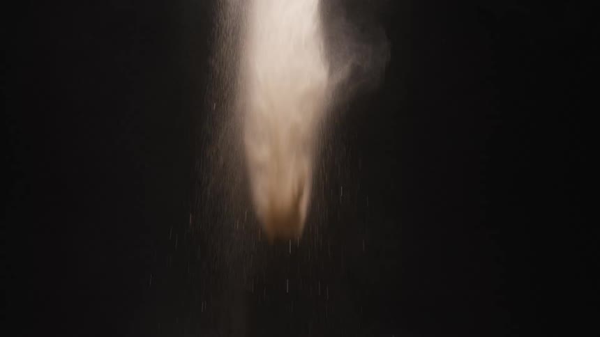 A wisp of smoke starts to drop then a large glob of it falls