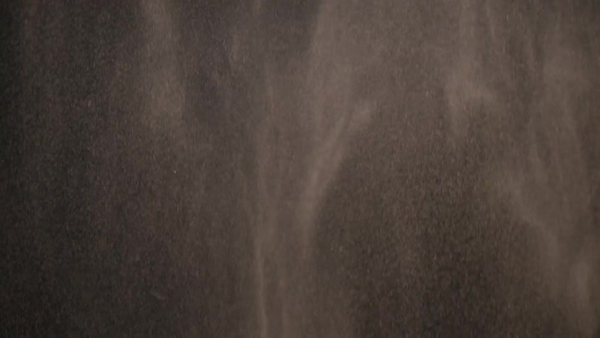 Dust slowly falls in the dark