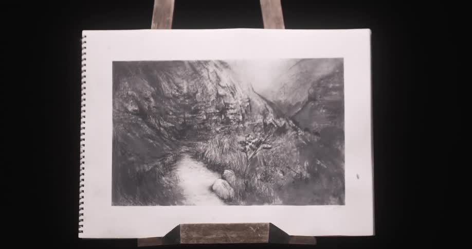 An easel sits in a dark room and a man puts a picture on it and walks away
