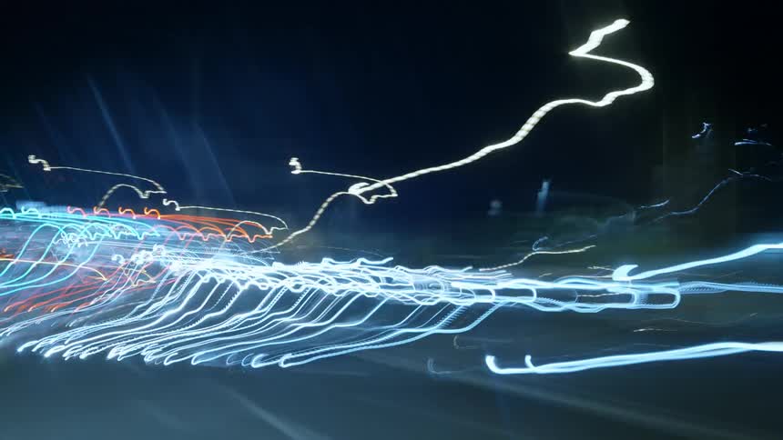Traffic lights and headlights sped up and blurred in flashing chaotic manner