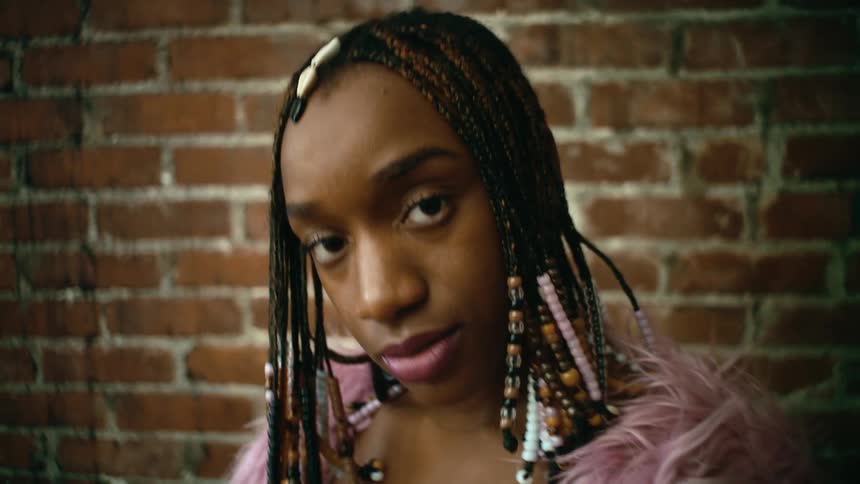 A young woman poses while looking into the camera