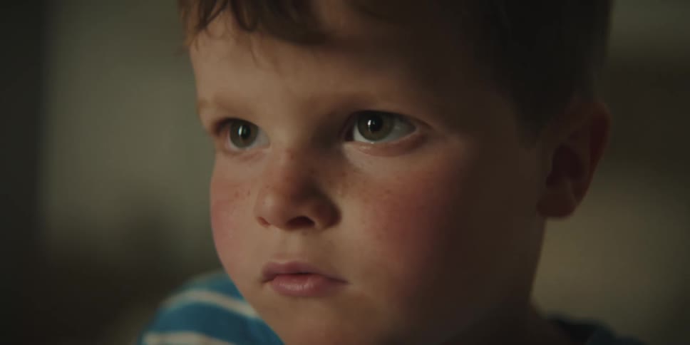 Rosy cheeked boy completely focuses on what he is watching