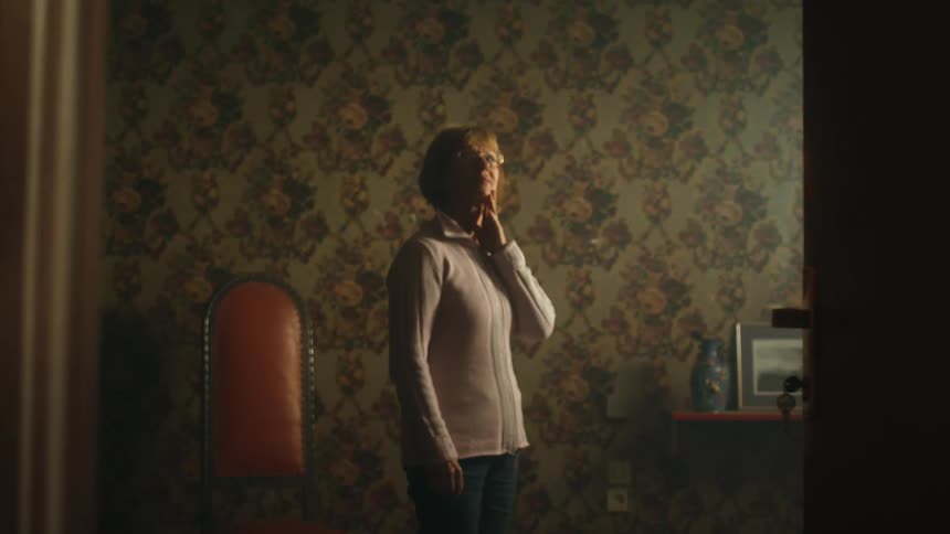 A view of a woman walking in a room