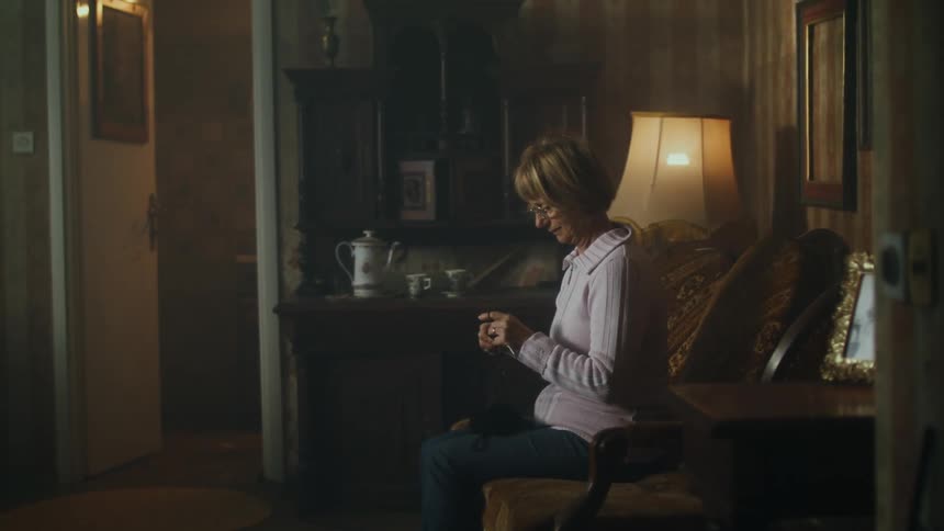 A woman is knitting at home