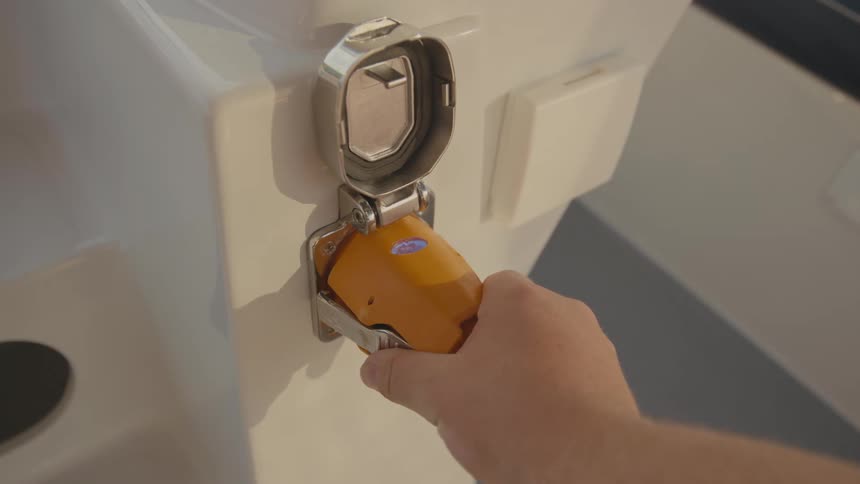 A persons hand pulls an electrical cord out of the outlet