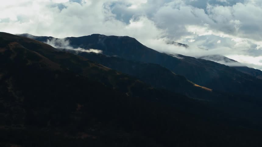 A mountain slope covered in vegetation on a cloudy day