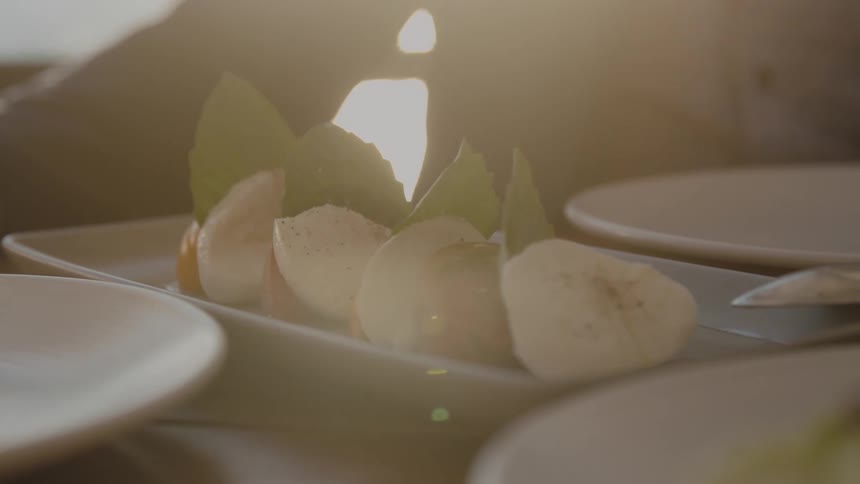 An appetizer sits on a table with empty dishes