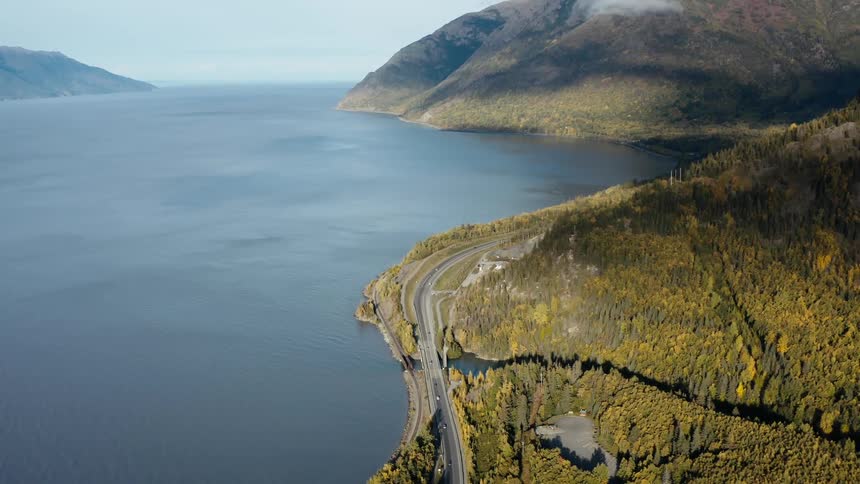 Aerial of a highway along a large body of water