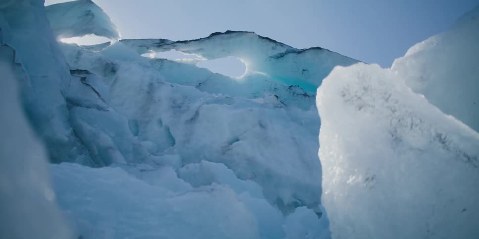 A large formation of ice under a clear daytime sky
