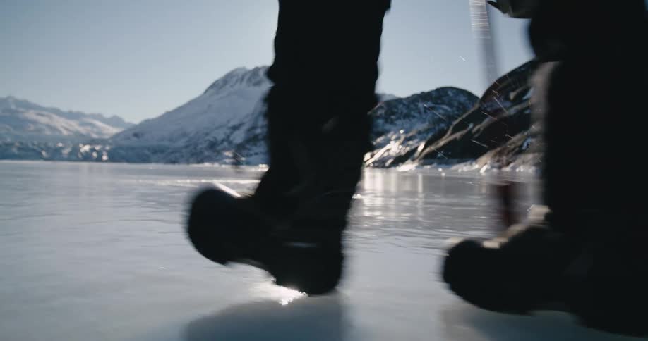 A view of someone walking on a frozen lake