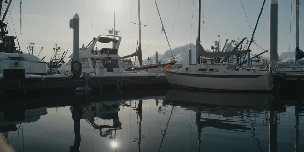 Boats moored at a dock on a winter day
