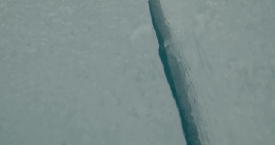 Close up view of ice melting on a glacier is displayed