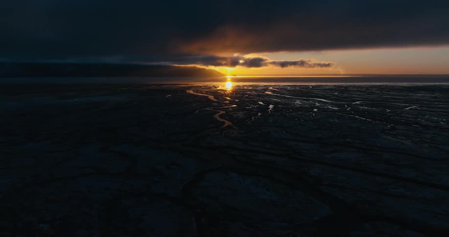 A landscape view of the sun setting over a desert area
