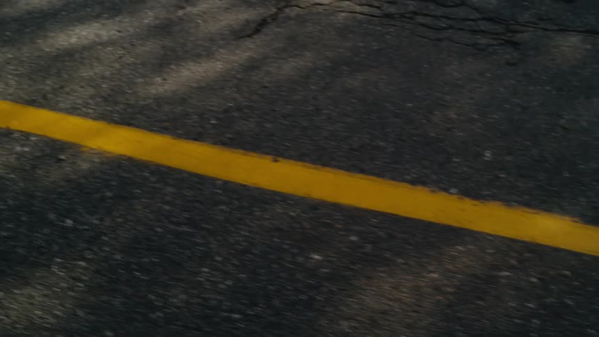 Close up view of an empty street is displayed at midday